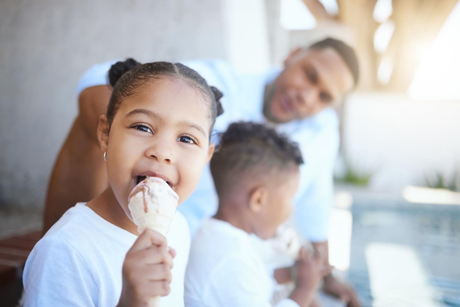 A family enjoying ice cream together outdoors