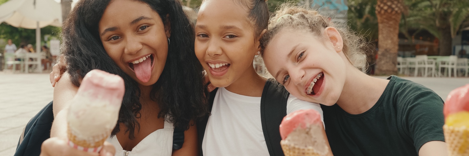 Friends enjoying ice cream together outdoors