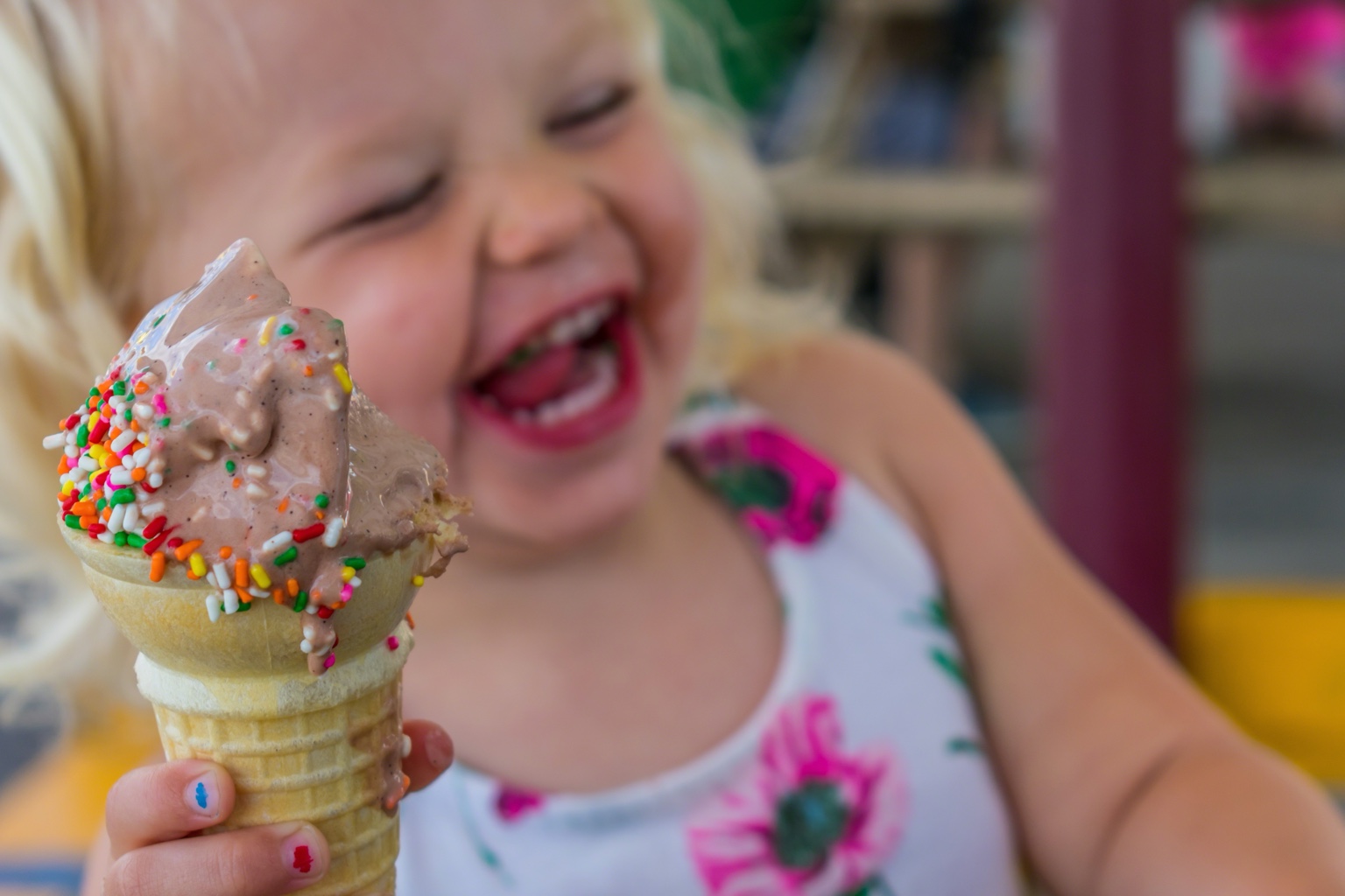 A delighted child holding an ice cream cone